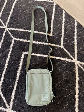 Lululemon Crossbody Bag in Sage Green with zipper adjustable and outside pocket